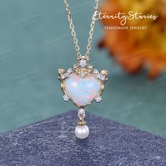 "Natural Opal Necklace Heart Opal Pendant Two Tones Vintage Yellow Gold Pearl Pendant Art Deco Diamond Cluster October Birthstone Gift Women Lab Opal Center listing: https://www.etsy.com/listing/1179605889 Item As Shown in Solid 14K Yellow Gold Also available in yellow gold, white gold, rose gold / Solid 14K & 18K △ center stone: Natural Fire Opal, Heart Shaped -Measures: 8mm △ side stones: 3.5mm Natural Akoya Pearl △ side stones: 0.065ct Colorless Moissanite / Natural Diamond (H, SI1) (select t Heart Shaped Jeweled Jewelry For Gift, Heart-shaped Jeweled Jewelry For Gift, Heart-shaped Jeweled Jewelry Gift, Opal Necklaces, Elegant Handmade Round Heart Necklace, Elegant Handmade Heart Necklace, Heart-shaped Wedding Jewelry, Heart Shaped Wedding Jewelry, Heart-shaped Wedding Jewelry With Jewels