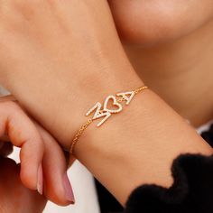 Combine your Initials with your Sweetheart in this Two Diamond Initials Bracelet with a heart. You're going to love the delicateness and the feelings that come pouring along with it. 1. Material Details ✧ Available Material: Gold Plated Sterling Silver / 10K Solid Gold / 14K Solid Gold / 18K Solid Gold ✧ Color Options for Gold Purchase:  Yellow / White / Rose ✧ Color Options for Silver Purchase: Yellow / White ✧ Stone Type for Gold Purchase: Natural Diamond ✧ Stone Type for Silver Purchase: Simulated Diamond 2. Stone Details ✧ Stone Type: Diamond ✧ Round 1.00MM: 57 pcs ✧ Round 1.10MM: 5 pcs  ✧ Diamond Quality: H Color / SI Clarity ✦ Total Diamond CTW: 0.30ctw 3. Shipping & Packaging Details ☐ Dispatches in 4 - 8 business days ☑ Multiple shipping speeds available 4. Returns * This product i Valentine's Day Anniversary Jubilee Diamond Bracelet, 14k Gold Diamond Bracelet For Valentine's Day Gift, White Gold Initials Bracelet For Anniversary, Personalized Diamond Bracelet As A Gift, Personalized Diamond Bracelet As Gift, Elegant Bracelets For Mother's Day Anniversary Gift, Elegant Chain Bracelet For Anniversary And Mother's Day, Diamond Bracelet With Heart Charm For Anniversary, Diamond Bracelets With Heart Charm For Anniversary