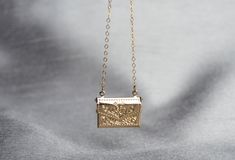 "This beautiful and personalized locket necklace would be a perfect Valentine's gift for any loved one! The gold plated letter locket charm measures approximately 21x16mm (including jump ring) and is hung on a 16\", 18\" or 20\" gold plated or 14k gold filled chain. The locket opens and you can add a tiny photo or sweet note inside. The chains are dainty and very pretty - the perfect delicate necklace for everyday wear. This sentimental gift is sure to be the recipient's favorite piece of jewelr Gold Rectangular Keepsake Necklace, Gold Rectangular Necklace For Keepsakes, Vintage Charm Necklace For Anniversary, Gold Locket Necklace With Hallmark For Mother's Day, Gold Locket Necklace For Mother's Day With Hallmark, Gold Locket Necklace For Mother's Day, Elegant Gold Locket Necklace For Wedding Gift, Gold Locket Jewelry Perfect For Gifting, Gold Jewelry Keepsake With Gift Box