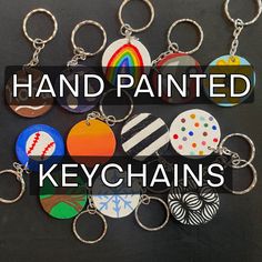 a bunch of key chains that are all different colors and shapes with the words hand painted on them