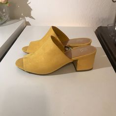 New York And Company Yellow Faux Suede Block Heel Slip On Mules Sandals Size 7. 2 1/2" Block Covered Heel. Man Made Materials. New With Tag. Smoke Free Home. Open To Reasonable Offers. Yellow Closed Toe Spring Mules, Yellow Synthetic Mules With Round Toe, Yellow Casual Mules For Spring, Block Heel Synthetic Sandals For Fall, Fall Synthetic Sandals With Block Heel, Fall Synthetic Sandals With Stacked Heel, Synthetic Block Heel Sandals For Fall, Trendy Suede Open Toe Heels, Yellow Suede Heels For Spring