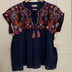 This Is A Size Small Nwt Altar’d State Shirt. It Has A Beautiful Multi-Colored Pattern On The Top, Flowy Babydoll Bottom Half, And Has Ties With Multi Colored Tassels. Perfect For Summer! Blue Crew Neck Blouse For Beach, Blue Cotton Bohemian Tops, Blue Bohemian Cotton Tops, Bohemian Blue Cotton Tops, Bohemian Blue Tops With Relaxed Fit, Casual Indigo V-neck Tops, Blue Bohemian Relaxed Fit Tops, Navy Short Sleeve Blouse For Summer, Bohemian Blue Relaxed Fit Tops