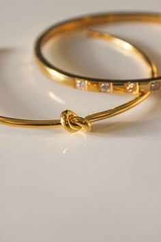 PRODUCT DESCRIPTION Joined together with the knot sculpture, it offers a feminine appeal and classy style. Knot Bangle is gracefully designed to sit around the contours of your wrist. Knot symbolizes a variety of things, such as love, friendship, unity, or loyalty. Get it now for your loved ones. Knot Design Water Resistant 18k Gold-plated on titanium steel Open bangle One Size: Oval Shape that fits small wrists from 14-16cm Read our full Jewellery Care Guide here Read our Sizing Guide here Adjustable Bangle With A Modern Twist As A Gift, Adjustable Bangle With A Modern Twist For Gifts, Modern Twist Adjustable Bangle As A Gift, Modern Twist Bangle As Gift, Adjustable Modern Twist Bangle, Knot Sculpture, Gold Minimalist Jewelry, Linen Pouch, Knot Bangle