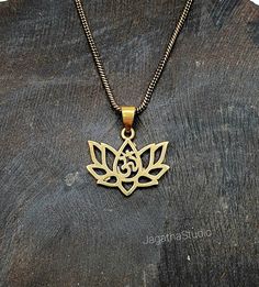 HANDMADE Beautiful dainty Lotus flower with Om symbol, sacred geometry pendant. The Om represents the whole Universe. It symbolise the unity of all things, that all things are one. The lotus is the symbol of what is divine or immortality in humanity, and is also a symbol of divine perfection. A symbol of purity, enlightenment, self-regeneration and rebirth. The attribute of sun and fire gods. It symbolizes the realization of inner potential and in Tantric and Yogic traditions the lotus symbolize Spiritual Oxidized Flower Pendant Jewelry, Spiritual Brass Jewelry With Oxidized Finish, Spiritual Engraved Flower Pendant Necklace, Spiritual Metal Charm Necklaces, Spiritual Engraved Flower Pendant Jewelry, Oxidized Pendant For Meditation, Oxidized Finish Pendant For Meditation, Spiritual Jewelry With Flower Charm Pendant, Spiritual Round Pendant Jewelry With Flower Charm