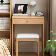 a wooden desk with a white chair next to it