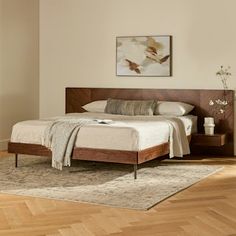 a bed sitting on top of a wooden floor next to a window