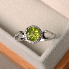 a ring with a green stone in it