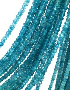 several strands of blue glass beads on a white background