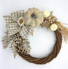 a wreath made out of branches and pumpkins