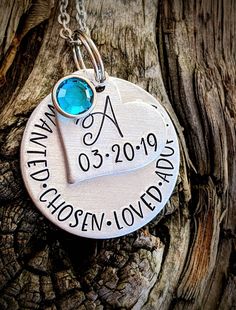 "Personalized hand stamped adoption necklace. Gift for adoption day. Gift for new daughter. Adopted daughter gifts. Adoption day jewelry. Custom adoption gifts. Daughter gift. Blended family gifts. Hand stamped and made to order. Made from a 1\" aluminum disc. Stamped with, \"Wanted. Chosen. Loved. Adopted.\" with dots in between. A 3/4\" aluminum heart is stamped with the child's name and included is a sparkly Swarovski crystal birthstone. Please see last photo for birthstone chart. All items a Hand Stamped Jewelry Gift For Father's Day, Hand Stamped Jewelry For Birthday And Mother's Day, Hand-stamped Jewelry For Birthday And Mother's Day, Hand Stamped Jewelry For Father's Day Personalized Gift, Hand Stamped Jewelry For Father's Day, Meaningful Hand Stamped Jewelry For Birthday, Birthday Jewelry For Mother's Day, Meaningful Hand Stamped Jewelry For Birthday Gift, Valentine's Day Birthday Stamped Jewelry