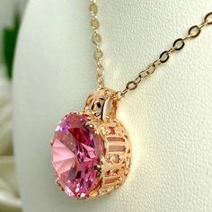 This is an amazing Art Nouveau style pendant. This necklace has a 12 carat Pink Cubic Zirconia (CZ) round gemstone. Set in rose gold plated sterling silver filigree, the detail of the filigree accents the lovely round cut of the faceted gemstone. The dazzling gemstone measures 15mm x 15mm. The 1.5mm rose gold necklace (if chosen) is adjustable from 18" to 20". All items are marked 925 to assure sterling silver quality. Rose Gold Crystal Round Jewelry, Rose Gold Crystal Jewelry, Pink Oval Cubic Zirconia Necklaces, Dazzling Pink Crystal Necklaces, Pink Oval Cubic Zirconia Necklace, Dazzling Pink Crystal Necklace, Pink Cubic Zirconia Round Pendant Jewelry, Pink Gold Cubic Zirconia Jewelry In Round Shape, Pink Gold Cubic Zirconia Pendant Jewelry