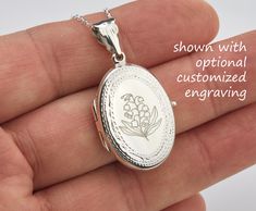 Also available in gold plated/rose gold plated over sterling silver. This elegant customized oval locket will help you keep the memories of your loved ones afresh: 1. One shining, highly polished sterling silver locket. (19 x 26 mm, about the size of a quarter, 4.6 grams). Its front has an etched decorative border. Its back is plain. Both sides can be custom engraved with initial, text or simple graphics.  2. There are two photo slots. Photo insertion service is available for $14 each photo (pricing reflected in your pulldown option. If you select " ... 1/2 photo", please send your locket photos by attaching them to an ETSY conversation to me. 3. a sterling silver or gold filled cross pendant     Upgrade is also available:     https://www.etsy.com/listing/736367470 4. an optional customize Oval Jewelry With Engraving Option For Memorial, Rose Gold Medallion Jewelry With Engraving Option, Silver Oval Jewelry For Personalized Gift, Oval White Gold Locket Necklace For Wedding, White Gold Oval Locket Necklace For Wedding, Elegant Oval Locket Necklace With Engraving Option, Personalized Silver Jewelry With Oval Link, Oval Locket Necklace With Engraving Option For Wedding, Oval Link Jewelry With Engraving Option For Gift