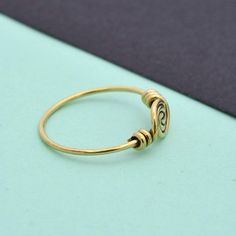 Cute spiral ring of Brass, handcrafted and lightweight. Stack with other gemstone rings, or wear it alone.❥ The spiral is one of the oldest symbols in the world. It appears in most ancient cultures across the globe and has many meanings, including progress, direction, and expansion. The Greeks related spirals to infinity, balance, and awareness.❥ Benefits of Brass Metal :Brass has metaphysical healing properties to boost the immune system and to give courage.It's known to help reduce inflammatio Minimalist Spiral Metal Jewelry, Handmade Vintage Spiral Jewelry, Minimalist Spiral Metal Ring Jewelry, Adjustable Spiral Midi Rings In Minimalist Style, Adjustable Metal Swirl Jewelry, Adjustable Spiral Nickel-free Jewelry, Nickel Free Spiritual Toe Rings, Spiritual Metal Toe Rings, Spiritual Nickel-free Toe Rings