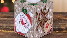 a christmas themed tissue box on a wooden table