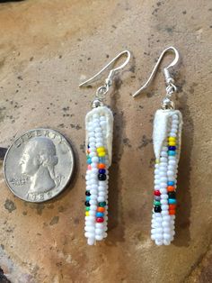 "Vintage Authentic Beautiful Native America Navajo Hand Beaded \"Healing Corn\" Earrings with Leather Husks. Hand Beaded by Navajo Artist R. Sellers ❤️ In common with many other Southwestern indigenous groups, corn is seen as the primary food for the Navajo (also known as the Diné). It is considered the mother, enabler, transformer and healer. Corn pollen is a crucial element in Navajo healing rituals, and is often carried by elder generations in a pouch worn around the neck for ceremonial use. Corn Earrings, Healing Rituals, Gilbert Az, Hand Beading, Indian Jewelry, Nativity, Corn, Dangle Drop Earrings, Dangle Earrings