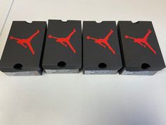 four black boxes with red jordan logo on them