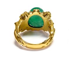 Antique Gold Large Cabochon Emerald Nude Lady Ring Dive into the enchanting realm of Art Nouveau with this magnificent gold ring, a testament to exquisite craftsmanship and artistic vision. This piece features a delicate assembly of sculpted ladies, each figure intertwined gracefully, representing the period's fascination with fluid, natural forms. At the center of this collective beauty sits a striking cabochon emerald, its lush green depths echoing the vibrant life of untouched nature. This si Gold Art Nouveau Jewelry With Intaglio, Art Nouveau Yellow Gold Collectible Rings, Collectible Art Nouveau Yellow Gold Ring, Art Nouveau Gold Ring With Gemstone, Art Nouveau Yellow Gold Intaglio Jewelry, Collectible Yellow Gold Emerald Cabochon Ring, Collectible Yellow Gold Emerald Ring With Cabochon, Art Nouveau Yellow Gold Ring, Elegant Oval Cabochon Emerald Collectible Ring