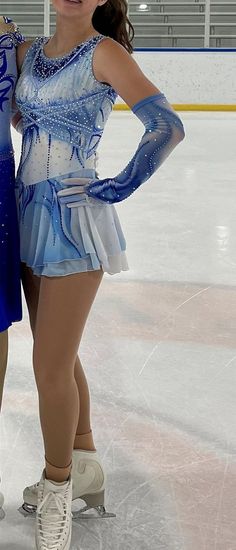 two female figure skaters posing for the camera