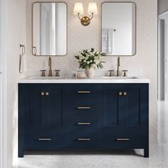 a bathroom with two sinks and mirrors on the wall