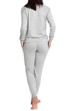 Some long pajamas feature a soft knit design against a crewneck top and matching jogger styled pants. Top has crewneck, long sleeves Pants have elastic waist 97% polyester, 3% spandex Machine wash, tumble dry Imported Model stats: 5'10" height, 32" bust, 25" waist, 36" hip. Model is wearing size S. Gray Stretch Sleepwear For Loungewear, Gray Sleepwear For Winter Lounging, Gray Long Sleeve Sleepwear For Winter, Gray Long Sleeve Casual Sleepwear, Gray Long Sleeve Winter Sleepwear, Heather Grey Long-sleeved Sweater For Loungewear, Long Pajamas, Matching Lounge Set, Womens Loungewear Sets