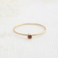 Ruby, July birthstone is set on Envero Jewelry's signature Dahlia setting which has a milgrain around the bezel setting to add elegant and feminine look to this simple ring. Choose from 2 or 3mm natural ruby and solid 14k yellow, rose or white gold. Perfect for simple ruby engagement ring - petite ruby matches perfectly when you wear it with our stack rings. Shop for matching ring: https://www.etsy.com/shop/EnveroJewelry?ref=l2-shopheader-name&section_id=17732059 ♦♦2mm Ruby ring♦♦ :: Small r Garnet Birthstone Ring In Fine Jewelry Style, Heirloom Solitaire Birthstone Ring Gift, Heirloom Style Solitaire Birthstone Ring As A Gift, Fine Jewelry Red Birthstone Stackable Rings, Red Birthstone Stackable Rings Fine Jewelry, Elegant Stackable Ruby Birthstone Ring, Elegant Red Stackable Rings With Bezel Setting, Classic Red Birthstone Jewelry, Dainty Red Solitaire Ruby Ring