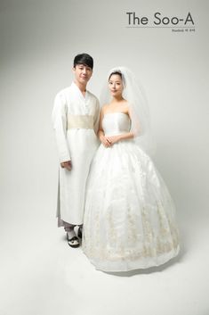 a man and woman dressed in wedding attire posing for a photo on their wedding day