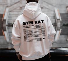 "Introducing our \" Gym Rat Nutrition Fact'' Hoodie--a funny and stylish addition to your gym wardrobe.This hoodie is packed with humor, featuring a playful \"nutrition label\" that proudly declares some gymrats characteristics. HOW TO ORDER: 1. Choose size/color options 2. Select the quantity 3. Click \"Add to Cart\" 4. Proceed to payment HOODIE MATERIAL: - 100% cotton (fiber content may vary for different colors) - Medium fabric - Classic fit - Tear-away label - Runs true to size SIZING: While these Hoodies are unisex and run true to size, we would recommend sizing up 1-2 sizes for an oversized look! CARE INSTRUCTIONS: - Machine wash cold, inside out - Hang dry or tumble dry low - Do not bleach or iron directly on design PROCESSING AND SHIPPING: 3-5 business days for processing Allow 7-1 Gym Fits For Men, Functional Gym Hoodie With Crew Neck, White Workout Hoodie With Letter Print, White Letter Print Workout Hoodie, White Letter Print Hoodie For Workout, Gym Hoodie With Letter Print In Relaxed Fit, Gym Hoodie Men, Peptide Therapy, Powerlifting Shirts