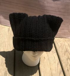 a black knitted hat on top of a white mannequin head