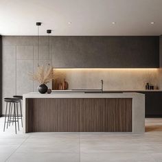 a modern kitchen with an island counter and bar stools