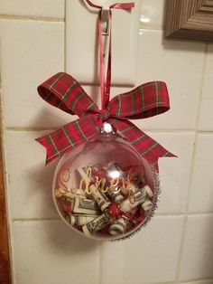 a christmas ornament hanging from the side of a wall with candy in it