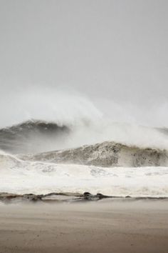 the waves are crashing on the beach