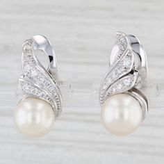 Gemstone Information: - Cultured Pearls - Size - 9 mm  Cut - Round Bead Shape Color - White - Natural Diamonds - Total Carats - 0.30ctw Cut - Round Brilliant Color - G - I Clarity - VS2 Metal: 14k White Gold Weight: 8.2 Grams  Stamps: K14, 560 Plat Closure: Clip On Non Pierced Measurements: 20.2 x 10.3 mm Each piece is thoroughly examined and refinished as needed by our professional jewelers, graded by our in-house GIA (Gemological Institute of America) Graduate Gemologist, and inspected for quality before being carefully packaged and promptly shipped. [SKU: A7037] phd Elegant Sterling Silver Diamond Earrings For Anniversary, Brilliant Cut Sterling Silver Pearl Earrings For Wedding, Elegant Pearl Earrings With Pave Setting In Diamond White, Elegant White Gold Diamond Earrings Aaa Quality, Diamond White Pearl Earrings With Diamond Accents For Anniversary, Anniversary Pearl Earrings With Pave Setting, Elegant Aaa Quality Round Cut Diamond Earrings, White Gold Clip-on Earrings For Anniversary, Silver Bridal Earrings With Pave Setting For Anniversary