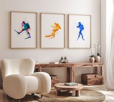 a living room with three art pieces on the wall