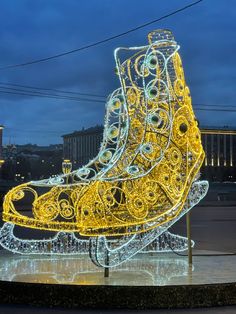 an illuminated sleigh in the middle of a plaza