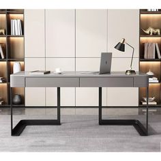 an office desk with a laptop on it in front of bookshelves and shelves