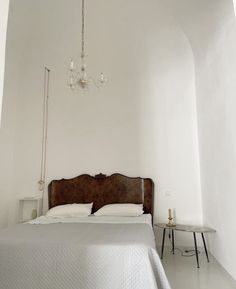 a bedroom with a bed and chandelier in it