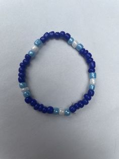 The Deep Blue Waters Bracelet is a bracelet made of seed beads. This comes in a set of 1. Blue Stretch Bracelet With Polished Beads As Gift, Gift Blue Stretch Bracelet With Polished Beads, Blue Colorful Beaded Friendship Bracelets For Beach, Beach Blue Friendship Bracelets With Colorful Beads, Blue Polished Beads Bracelets For Gift, Blue Friendship Bracelets With Colorful Beads For Beach, Blue Beaded Bracelets With Polished Beads As Gift, Light Blue Beaded Bracelets With Round Beads, Blue Jewelry With Colorful Beads For Friendship