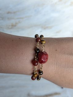 Unleash the power of nature with our stunning red jasper and tiger's eye bracelet, intricately crafted with a handmade chain. Red jasper is known for its grounding properties, promoting stability and endurance, while tiger's eye enhances courage and strength. Each bracelet is a one-of-a-kind creation, brimming with the potent energy of these remarkable stones. Embrace the unique power of this bracelet and embark on your journey with confidence and resilience. https://www.etsy.com/listing/1718274 Handmade Jasper Bracelets As Gifts, Handmade Red Chain Bracelet As Gift, Handmade Red Chain Bracelet For Gift, Handmade Red Chain Bracelet Gift, Adjustable Jasper Bracelet Gift, Jasper Beaded Bracelets With Natural Stones As Gift, Handmade Jasper Beaded Bracelets Gift, Red Natural Stones Bracelets For Gift, Adjustable Spiritual Garnet Jewelry