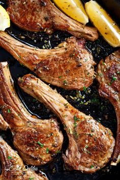 steaks and lemon slices in a cast iron skillet