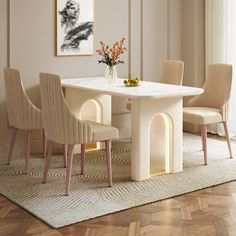 a dining table with chairs around it and a vase on the table next to it