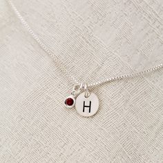 "January Birthstone Initial Necklace, Garnet Jewelry, January Birthday Gift, January Birthstone Jewelry,Personalized, Sterling Silver Garnet Lovely January Birthstone Garnet Necklace. For babies born in January, the garnet is the perfect gem to represent their birthstone. This beautiful stone, which is most commonly red but can be found in a range of other colors, symbolizes peace, prosperity and good health. Some say it even has the power to give the wearer eternal happiness, health and wealth. Red Charms Jewelry For Birthday, Personalized Red Jewelry For Birthday Gift, Valentine's Day Birthday Birthstone Necklace, Silver Birthstone Necklace For Birthday With Round Pendant, Silver May Birthstone Necklace For Birthday, Birthstone Necklace For Birthday And Valentine's Day, Silver Birthstone Necklace For May Birthdays, Valentine's Day Birthstone Charm Necklace, Sterling Silver Name Birthstone Necklace For Birthday