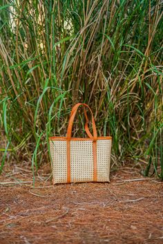 Our Bella rattan and leather trim tote is a classic fun way to complete any look this season. Our handbags are all handmade. Want to add a little something special to your handbag? Accessorize with our 100% silk scarves. Ready to ship! Please allow 1-2 business days to process your order and ship. Details: Rattan Leather trim Handmade Made in Indonesia 14.75” (L) x 11.5” (W) x 12” (H) Feminine Winter Outfits, Feminine Fall Outfits, Feminine Summer Outfits, Spring Jumpsuits, Everyday Casual Outfits, Modern Feminine, Light Coat, Silk Scarves, Cozy Sweaters