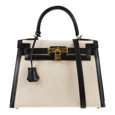 Hermes * Kelly 28 Sellier 2way Shoulder Handbag Beige Black Toile H Box Calf    Engraved / Number :  14C □ F ;Production in 2002    Pocket :  Outside: -, Inside: Zipper Pocket*1, Pocket*2    Size(Inch) :  W 11.4 x H 8.7 x D 4.7 " Handle Drop. 3.5 ", Strap Drop. 17.7 "    Size(cm) :  W 29.0 x H 22.0 x D 12.0 cm Handle Drop. 9.0 cm, Strap Drop. 45.0 cm    Color / Material :  Beige, Black / Toile H, Box Calf    Comes with :  Shoulder Strap, Padlock, Key x2, Key cover, Dust Bag, Dust Bag for Shoulde Designer Canvas Bag With Top Handle For Errands, Luxury Canvas Bag With Top Carry Handle For Errands, Luxury Cream Tote Bag, Classic Handheld Satchel With Dust Bag, Designer Canvas Bag With Top Handle For Daily Use, Designer Beige Satchel With Top Carry Handle, Luxury Canvas Bag With Top Handle, Luxury Satchel Canvas Bag For Daily Use, Designer Beige Top Handle Canvas Bag