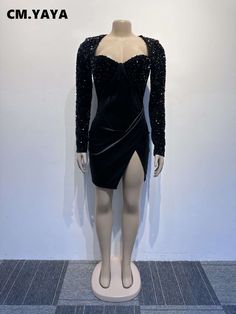 a mannequin wearing a black dress with sequins on it