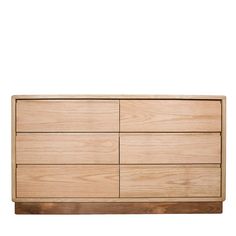 a wooden dresser sitting on top of a white wall