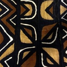 an image of a black and gold pattern on fabric with white lines in the middle