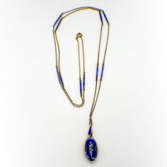 "Antique gilt 935 sterling silver long chain necklace, decorated with blue & black enamel bar links, and holding oval form miniature watch pendant, also decorated with blue and black enamel and featuring depiction of a cupid playing the flute. The watch has wind-up mechanism, runs. This stunning necklace measures: the chain is 32\" long, the watch is 1\" tall and 5/16\" wide, weighing a total 18.8 grams. EA2587" Oval Enamel Locket Jewelry, Formal Oval Necklace With Black Enamel, Formal Oval Black Enamel Necklace, Oval Locket Necklace In Enamel, Oval Enamel Locket Necklace, Blue Enamel Locket Jewelry, Blue Jewelry With Black Enamel For Formal Occasions, Blue Oval Enamel Necklace, Enamel Hallmarked Oval Pendant Necklace