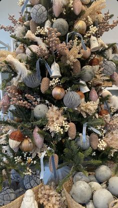 a christmas tree decorated with ornaments and pine cones