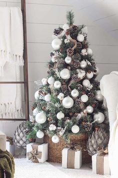 a christmas tree with white and silver ornaments