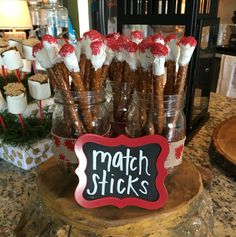 there is a sign that says match sticks in front of some cookies and marshmallows